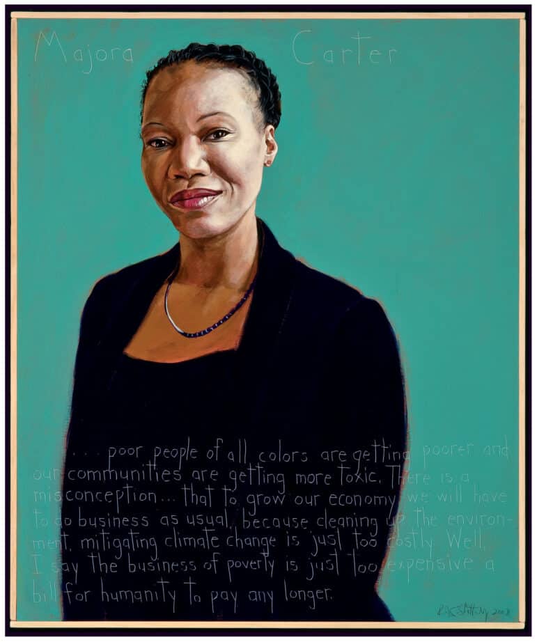 A portrait of Majora Carter, a Black woman with a short protective hairstyle. She is wearing a black dress and jacket with a black necklace. Her background is turquoise. 
