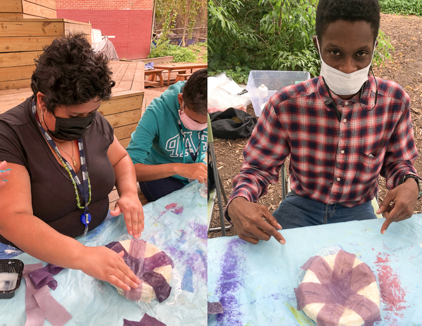 This is split image of volunteer artists. Left: Two people are placing purple fabrics on a circular frame that looks like a bowl. They are both masked. RIGHT: One person points with happiness in his eyes (his face is otherwise masked) at his complete purple flower.