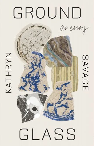The cover for "Groundglass". It is a beige cover. In the center of it is a pile of six rounded shapes with various rock and glass patterns (swirls of blue, veins of balck, patches of black and white). The shapes overlap